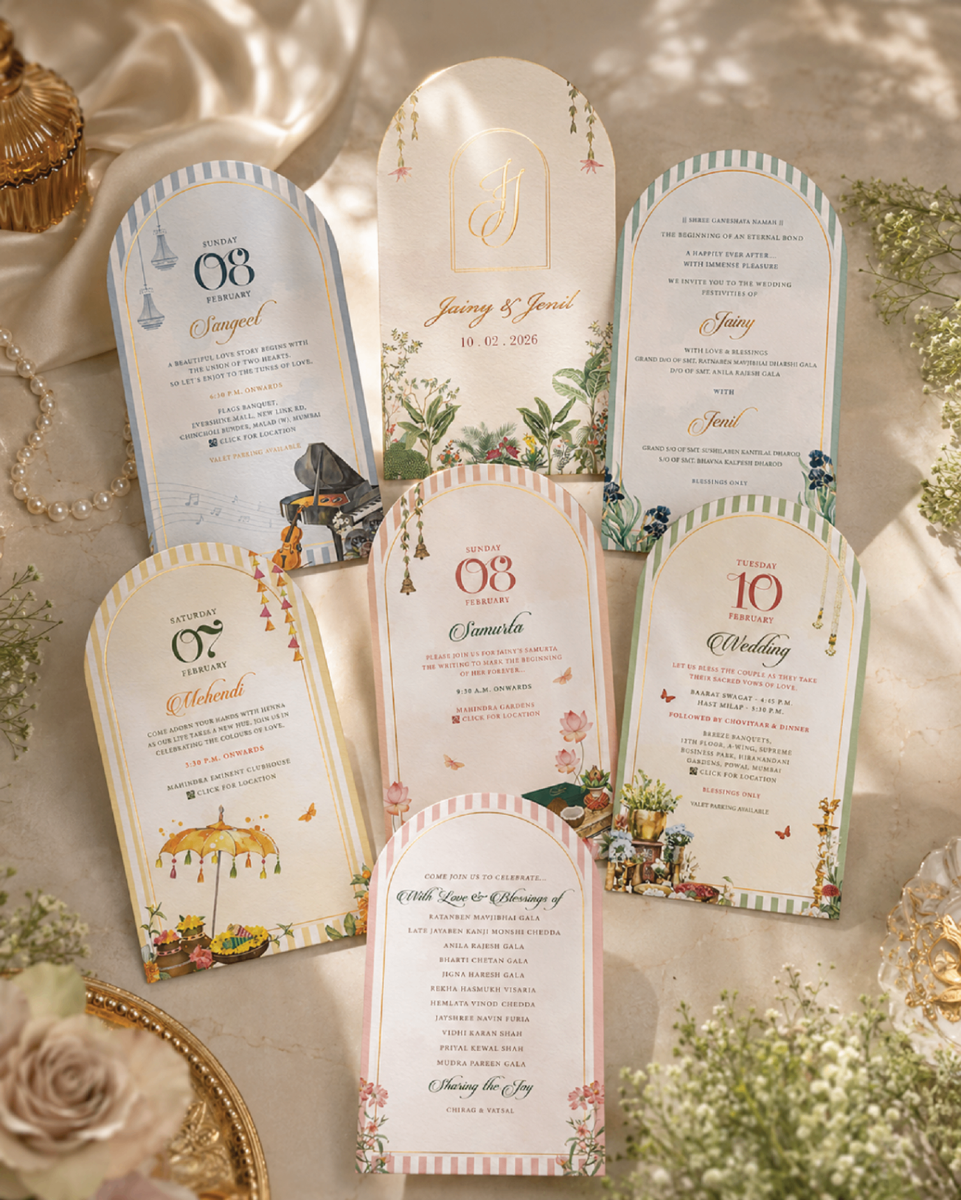 Arched pastel wedding invitation set displayed together as a complete stationery suite.