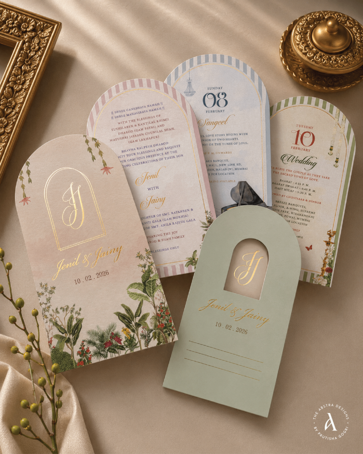 Arched pastel invitation suite with botanical florals and coordinating gift tag.